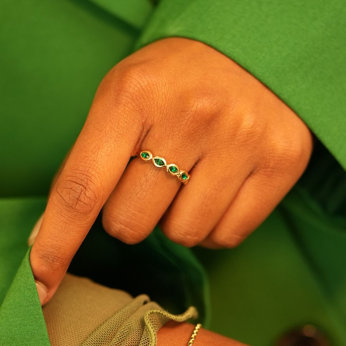 The Stacking Ring flaunts a delicate band adorned with encased marquise stones. Its versatility lends it the ability to stand out as a statement piece or be customised by pairing with complementary rings.