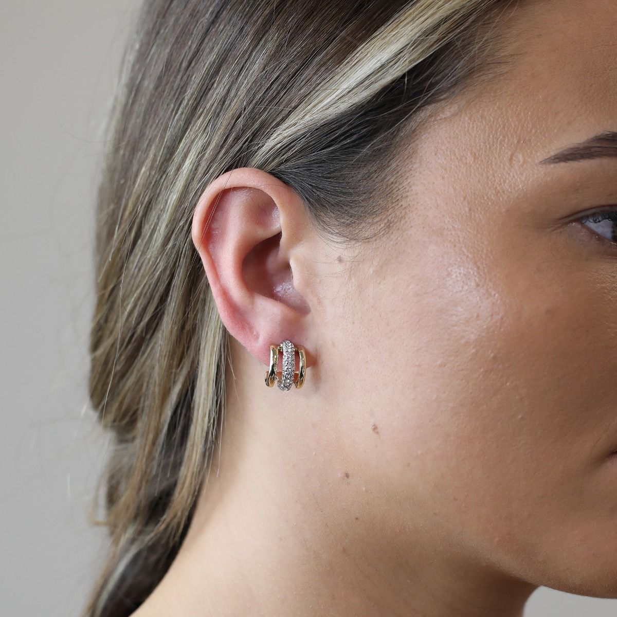 These beautiful half hoop earrings from the Aspire collection will add sophistication to any outfit. Featuring shimmering pave set crystals set into rhodium plating, wrapped between two bands of polished gold