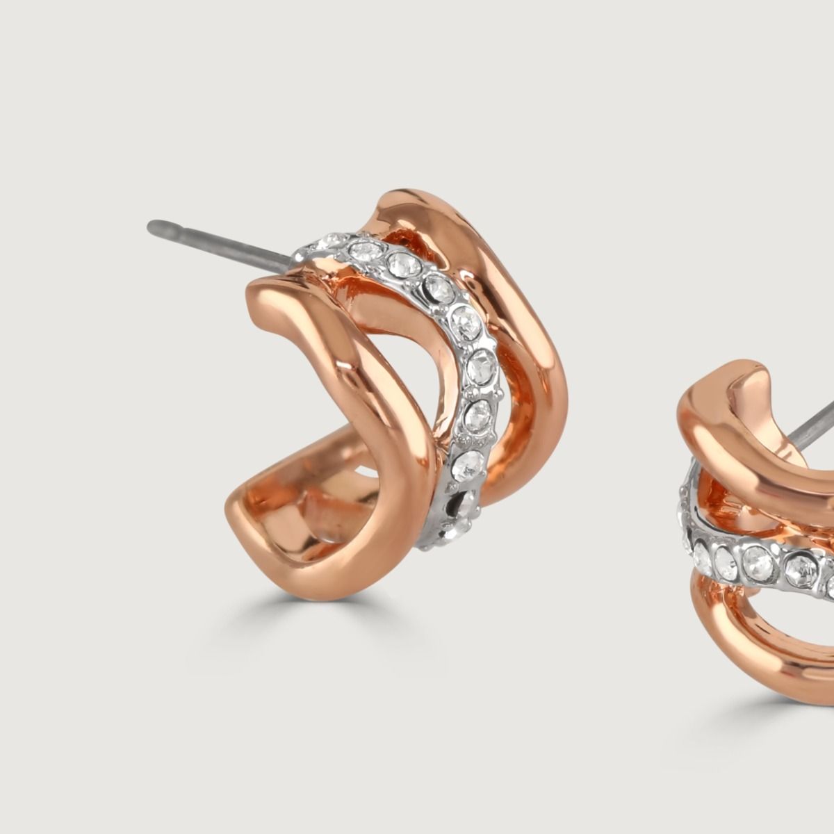 Modern and luxurious, the Bayswater half-hoop earrings are designed with soft swirls of champagne rose gold and rhodium-plated bands finished with subtle white crystal details. 