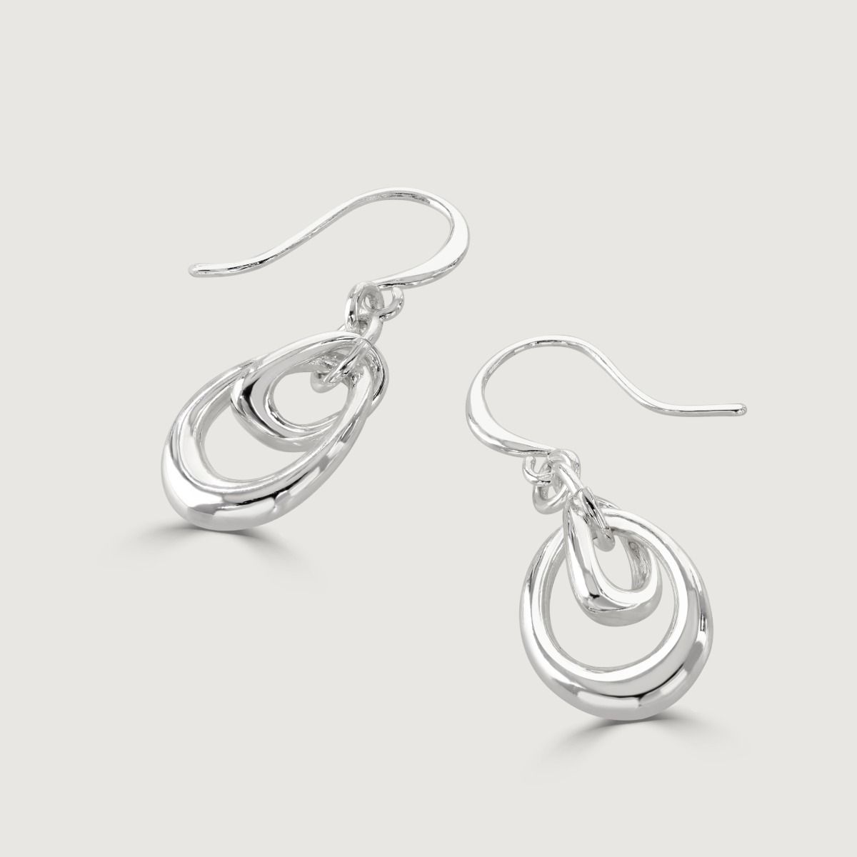 The Silver Organic Double Hoop Drop Earrings are exquisite pieces of jewelry that showcase elegance and style. With intertwining hoops and a lustrous silver shine, these earrings make a statement while symbolizing unity and connection.