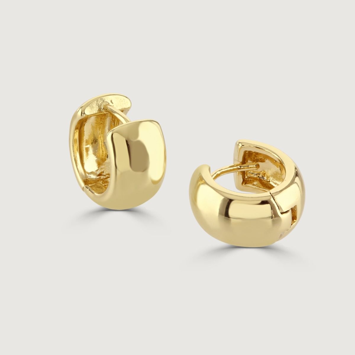 The Gold Polished Chubby Huggie Earrings perfectly takes a twist on an everyday classic. The huggie style ensures a comfortable fit whilst elevating any outfit.
