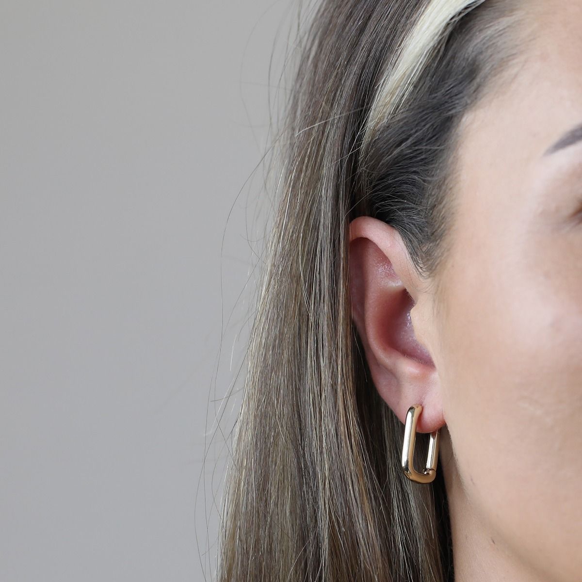 The Rectangle Polished Gold Hoop Earrings are a contemporary and sleek piece. With their polished gold finish and rectangular shape, these hoop earrings exude a modern and sophisticated style. The geometric design adds an element of interest. 