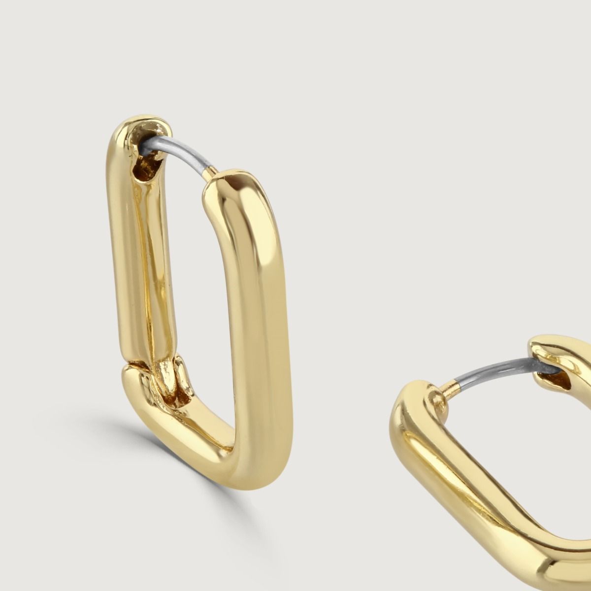 The Rectangle Polished Gold Hoop Earrings are a contemporary and sleek piece. With their polished gold finish and rectangular shape, these hoop earrings exude a modern and sophisticated style. The geometric design adds an element of interest. 