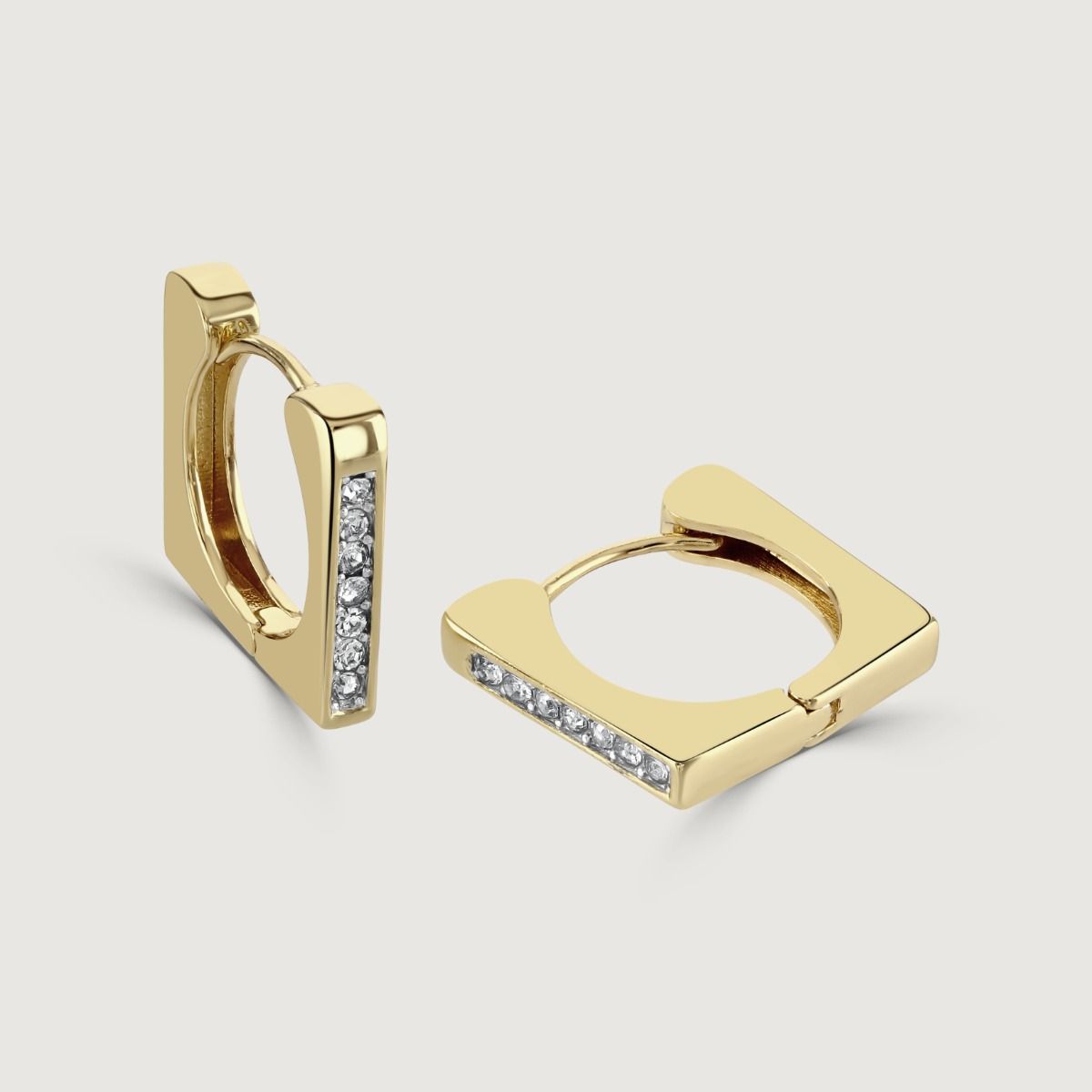 The Square Crystal Huggie Earrings are dazzling accessories that effortlessly combine elegance and sparkle. With their square shape and embedded crystals, these huggie earrings exude a sophisticated charm. 