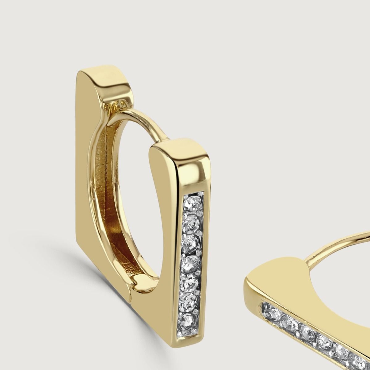 The Square Crystal Huggie Earrings are dazzling accessories that effortlessly combine elegance and sparkle. With their square shape and embedded crystals, these huggie earrings exude a sophisticated charm. 