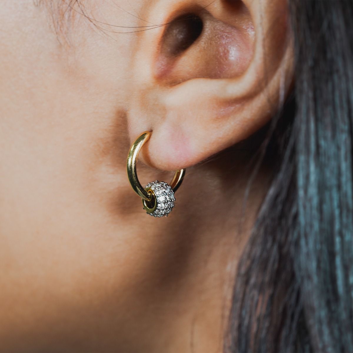 Elevate your style with our Two-Tone Pave Barrel Hoop Earrings. These exquisite earrings combine a polished gold hoop with a cubic zirconia encrusted barrel. Perfect for adding a touch of sophistication and eye-catching detail to any outfit. 
