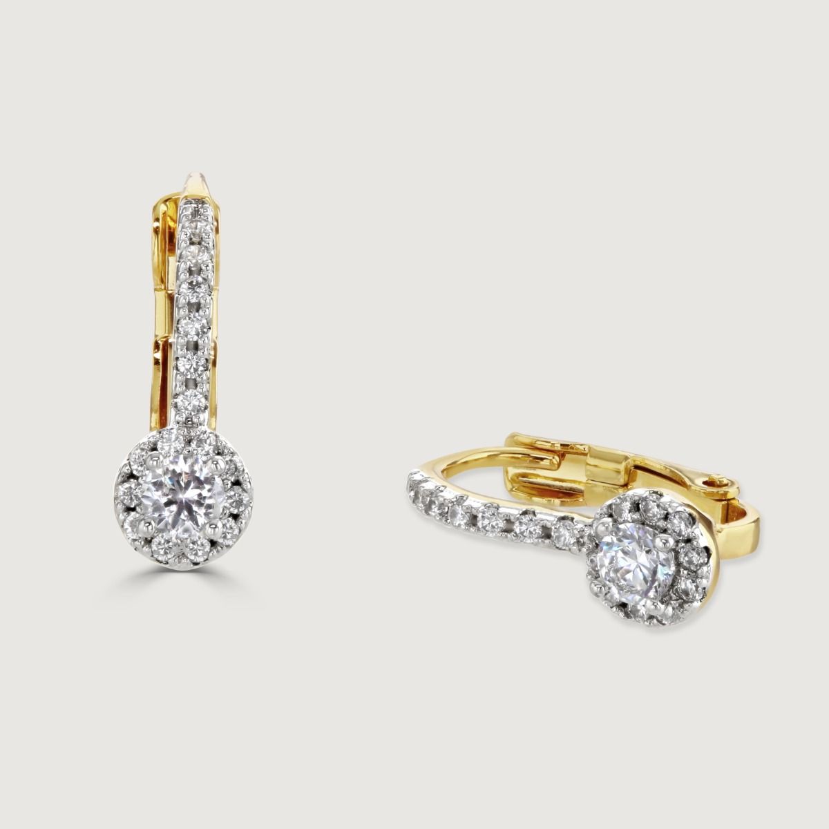 The Pave Hoop Drop Earrings are adorned with cubic zirconia stones along the hoop. It features a suspended round cubic zirconia stone, surrounded by more sparkling gems, which adds a captivating finishing touch. 