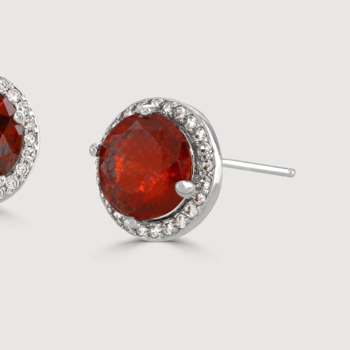 Experience enchantment through our Ruby Halo Earrings. The impressive round-cut centre stone emanates a captivating allure. Effortlessly elevate your style with this exquisite piece, infusing timeless glamour into any ensemble.