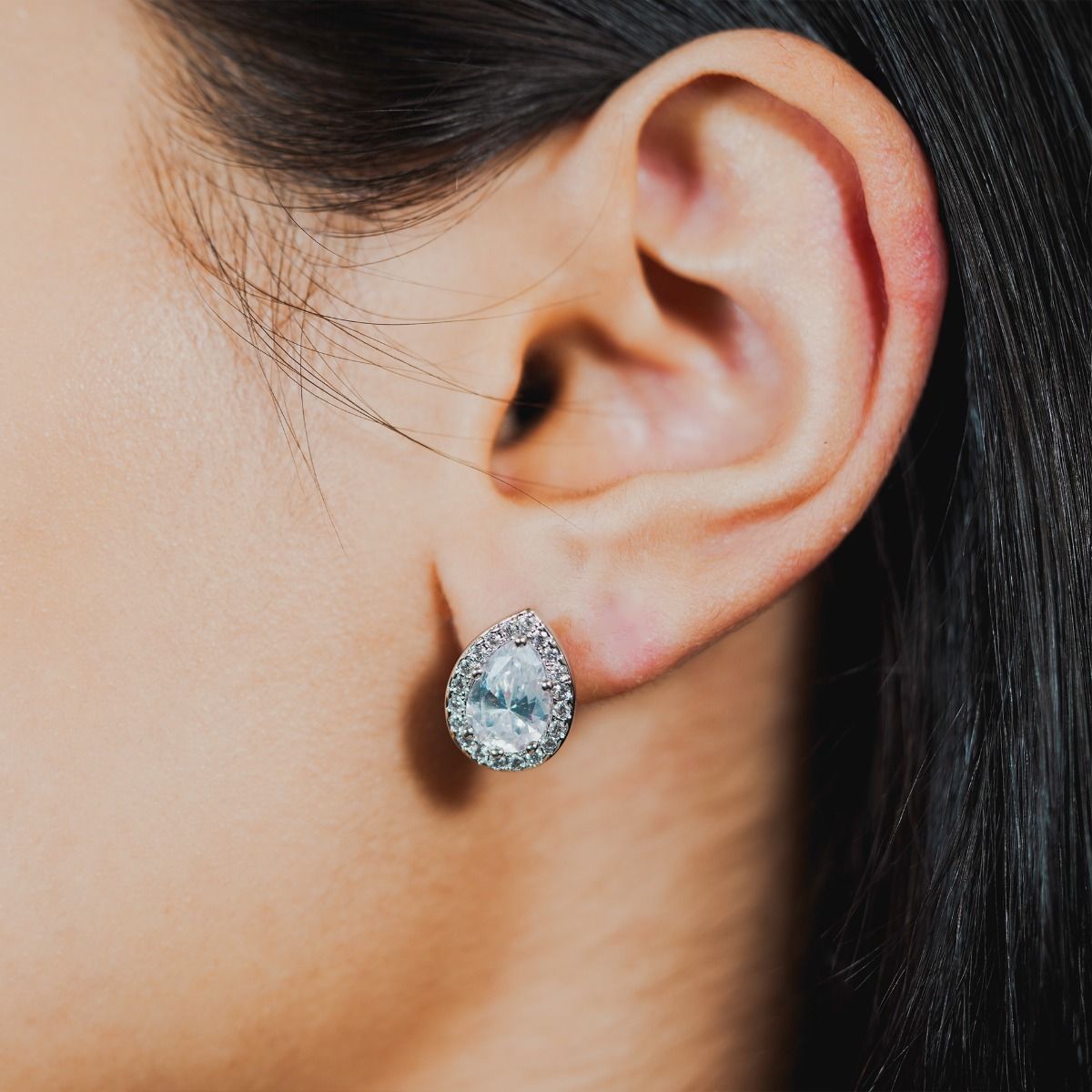 These beautiful stud earrings are set with flawlessly cut cubic zirconia stones, surrounding a dazzling oval cut centre stone. Wear to add timeless glamour to any look.