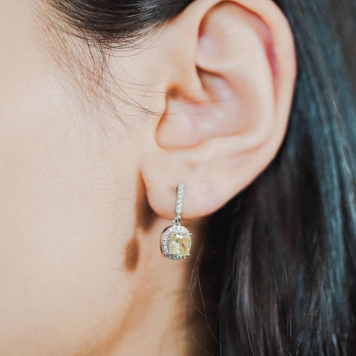 These striking stud drop earrings are set with flawlessly cut cubic zirconia stones, surrounding a dazzling canary cushion cut centre stone. Wear to add timeless glamour to any look.
