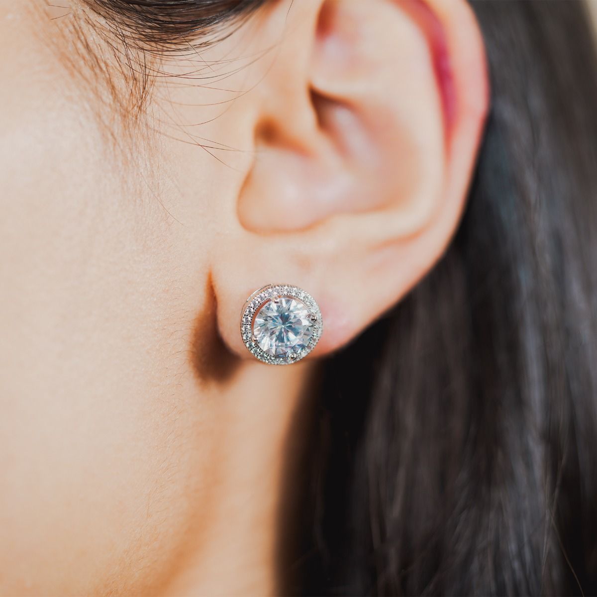 These dazzling stud earrings are set with a halo of flawlessly cut cubic zirconia stones, surrounding a dazzling round clear centre stone for a diamond inspired look. Wear to add timeless glamour to any look.