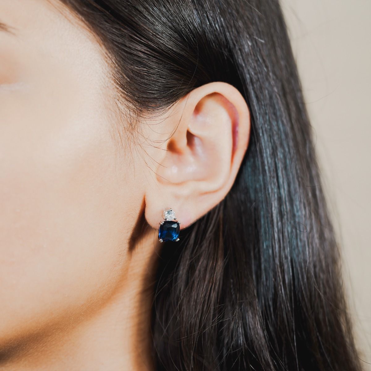 These show stopping stud earrings are set with a flawless brilliant cut cubic zirconia above a striking cushion cut Sapphire coloured stone. Wear to add timeless glamour to any look.