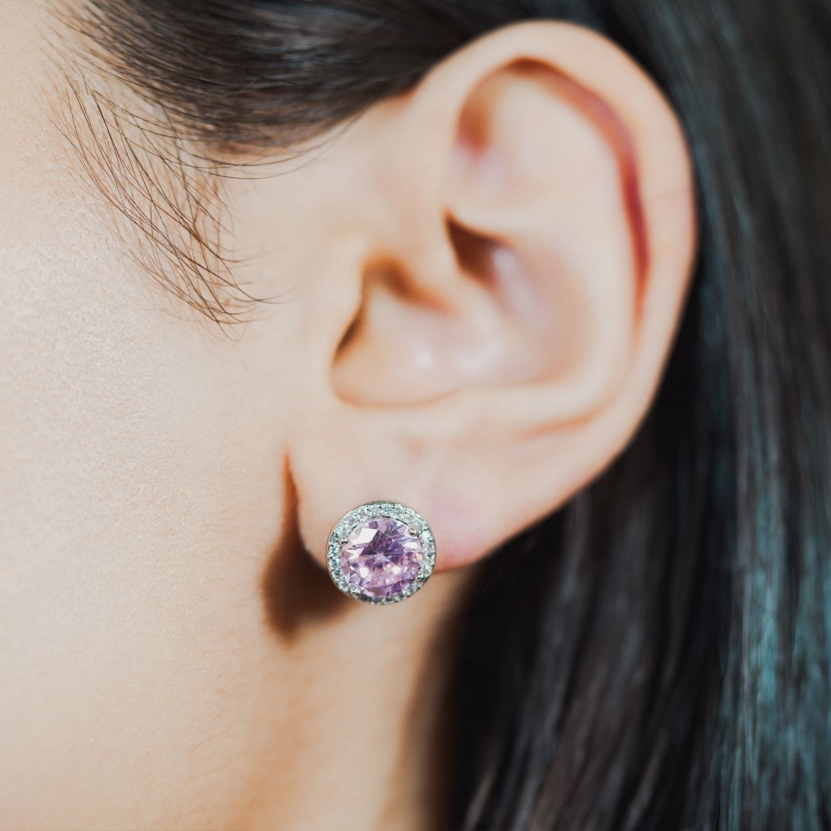 These dazzling stud earrings are set with a halo of flawlessly cut cubic zirconia stones, surrounding a sparkling round pink centre stone. Wear to add timeless glamour to any look.