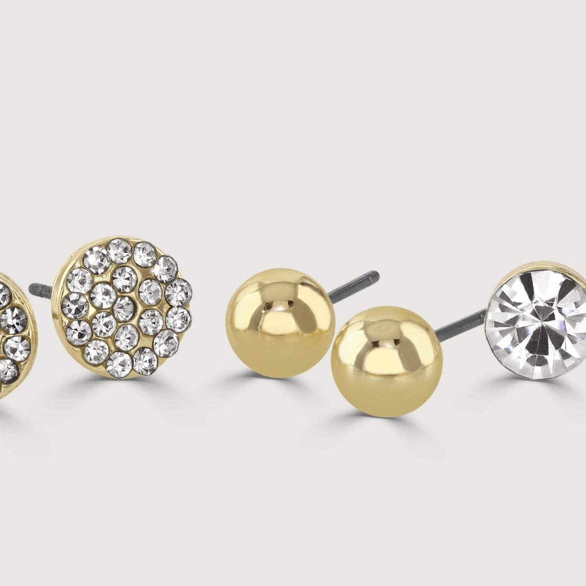 Revitalise your earring collection with this stunning Gold Four Piece Earring Pack. It includes a variety of styles, such as plain studs for a classic touch, sparkling crystal earrings for added glamour, and square-shaped earrings for a modern twist. 