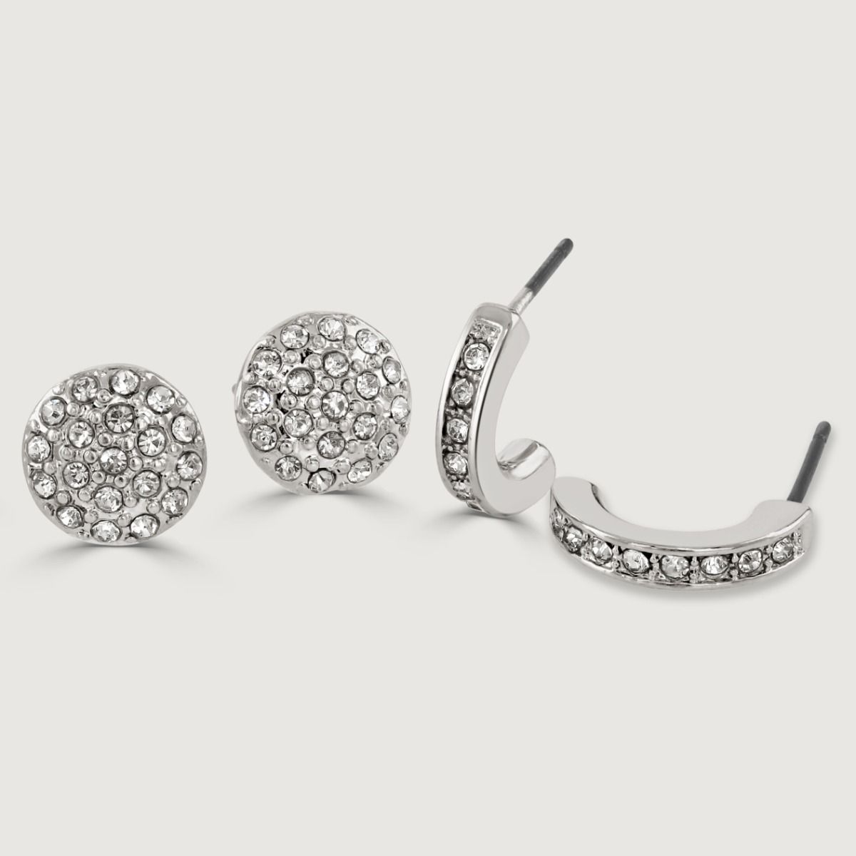 Upgrade your earring collection with this dazzling Rhodium Four Piece Pack. It features a mix of timeless elegance and contemporary flair, including pearl studs for a touch of sophistication, chic hoop earrings for a trendy look, and sparkling crystal ear