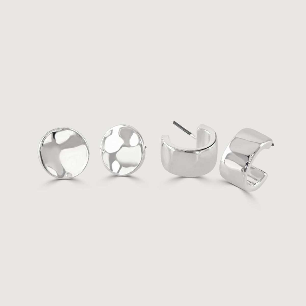 The Set of Two Silver Stud Earrings is a versatile piece. Crafted with precision and care, these earrings feature a sleek silver finish that exudes elegance. 