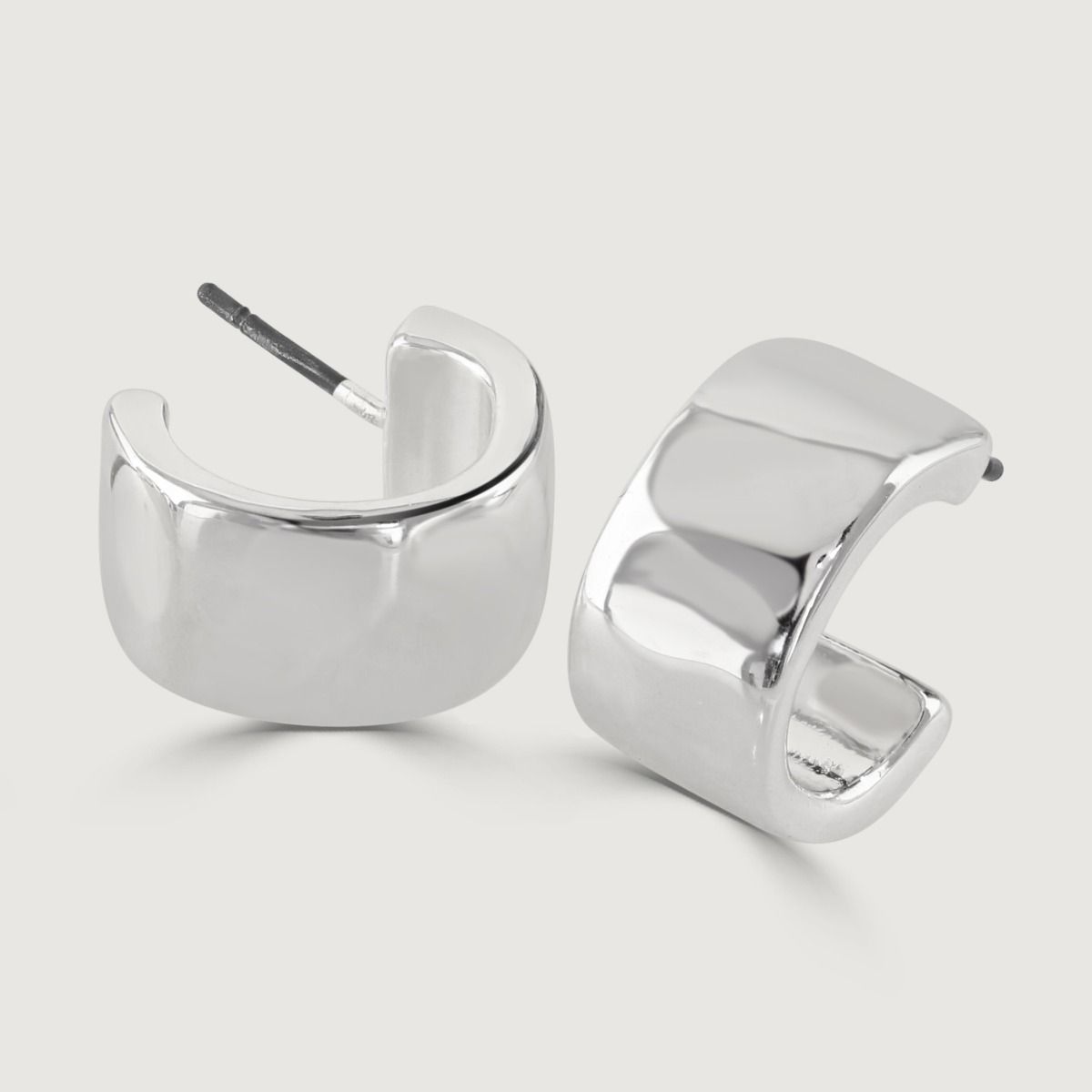 The Set of Two Silver Stud Earrings is a versatile piece. Crafted with precision and care, these earrings feature a sleek silver finish that exudes elegance. With two different designs in the set, they offer versatility to suit any occasion and add a touc