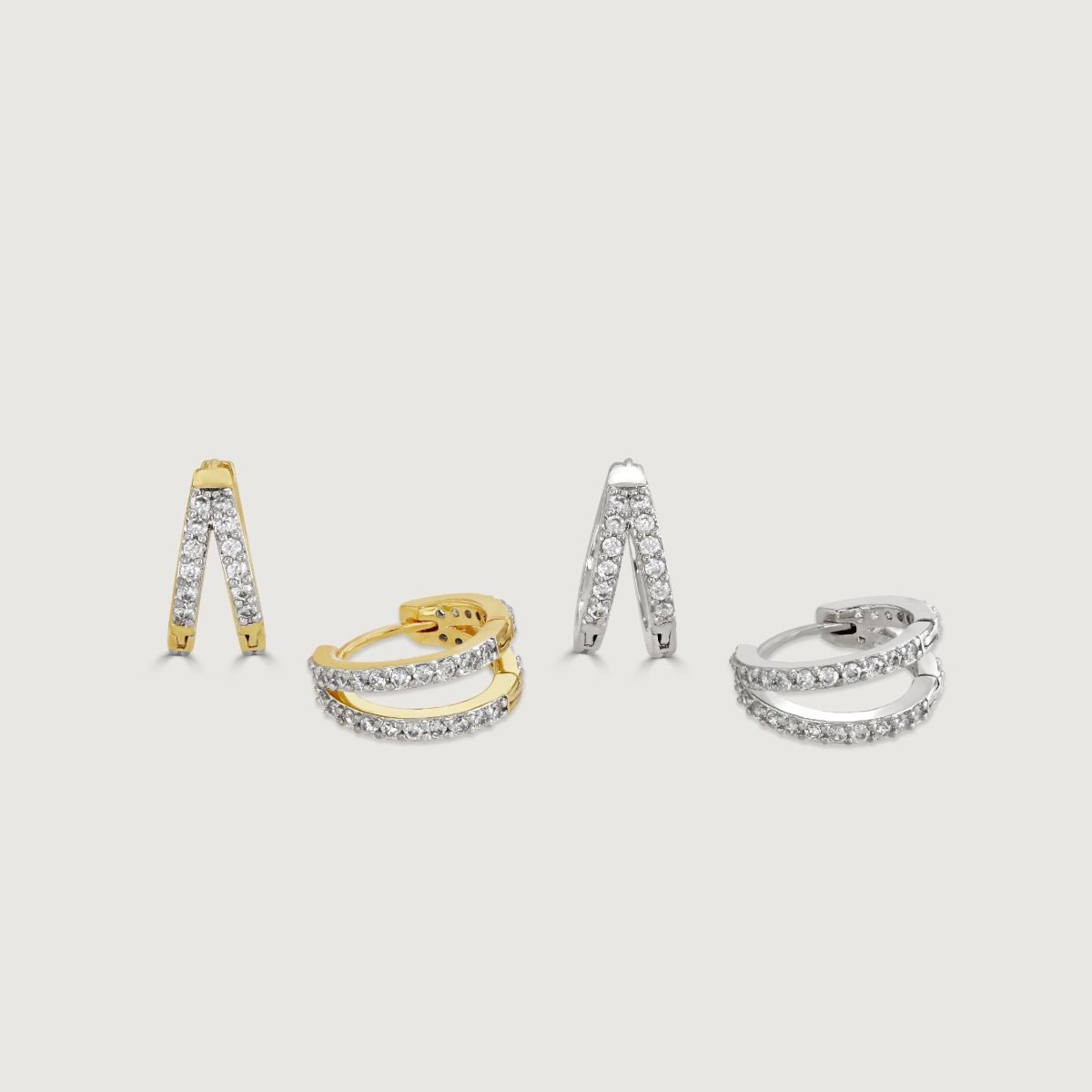The Duo Pave Hoop Set showcases two sets of double-attached pave hoops. Crafted in elegant rhodium and exquisite two-tone pave, these hoops add a touch of brilliance and sophistication to any look, making them the perfect accessory for any occasion.