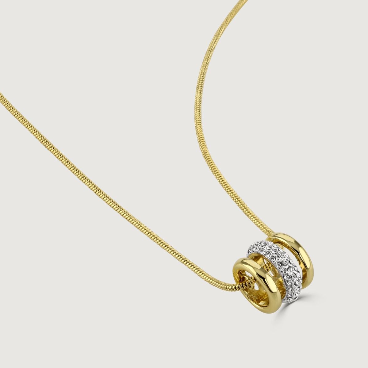 Simple and chic, the Aspire pendant is the perfect accessory for any outfit. Suspended from a sleek gold plated snake chain, the pendant features shimmering pave set crystals set into rhodium plating, wrapped between two bands of polished gold plate. Wea