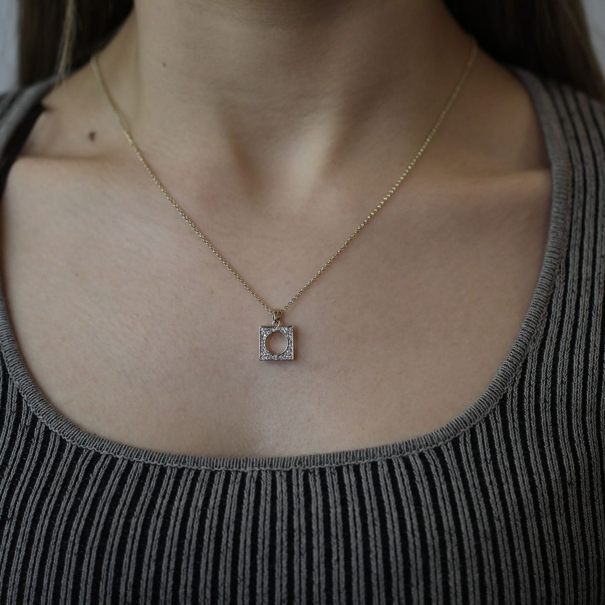 The Square Crystal Pendant is a captivating piece of jewellery that radiates elegance and brilliance. With its square shape and sparkling crystal centrepiece, this pendant exudes a refined charm. 