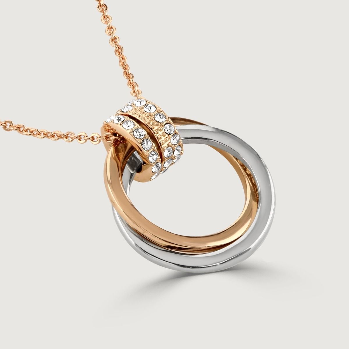 This crystal double hoop pendant encapsulates sophistication with its classic design and modern twist. It effortlessly pairs rhodium and rose gold plating together which makes this the ultimate styling piece. 