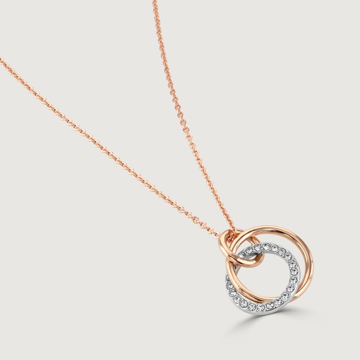 This crystal and polished two-tone pendant encapsulates sophistication with its classic design and modern twist. It effortlessly pairs together rhodium and rose gold hoops, which are finished off with crystals. 
