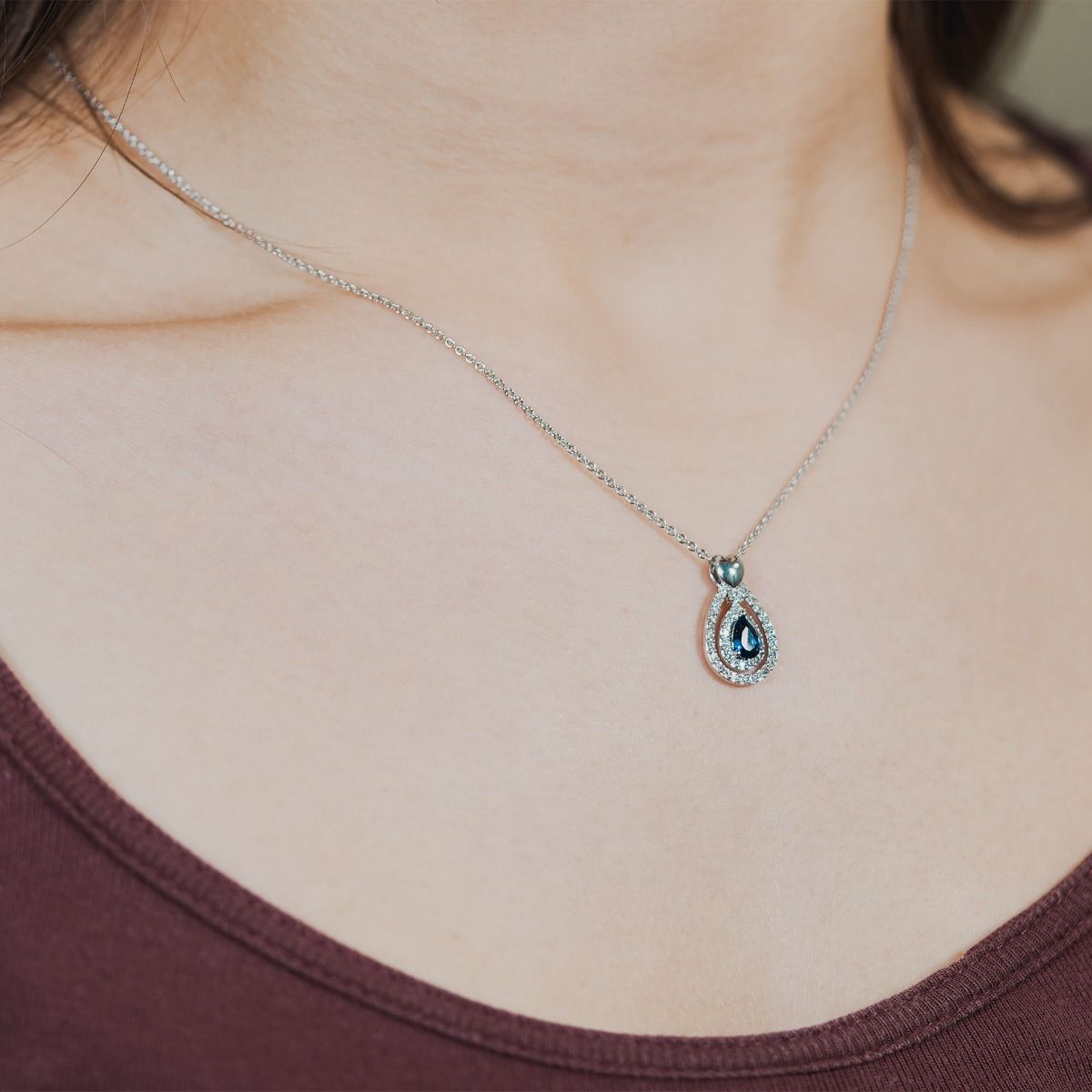 Discover elegance with our Sapphire Heart Pear-Drop Pendant. Enhanced by twin cubic zirconia pear-drop bands, it features a polished heart on the bale. The enchanting focal point is a captivating sapphire stone.