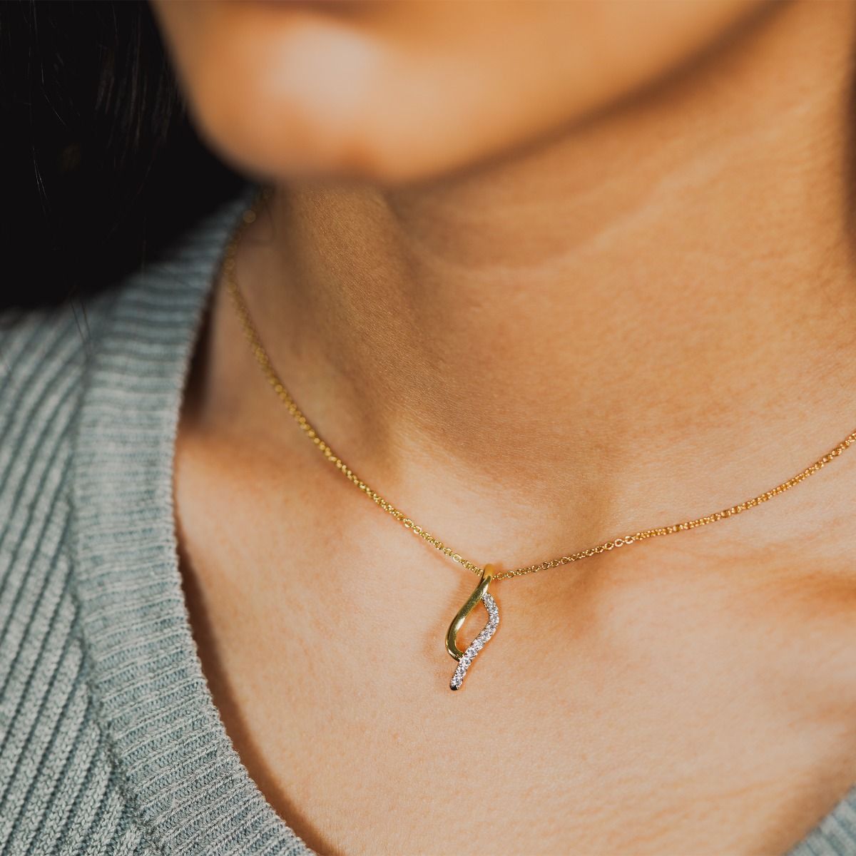 Elevate your style with the Two-Tone Pave and Polished Tide Necklace. Crafted with precision, this necklace showcases intertwining gold-polished and cubic zirconia pave bands, creating a captivating organic design. 