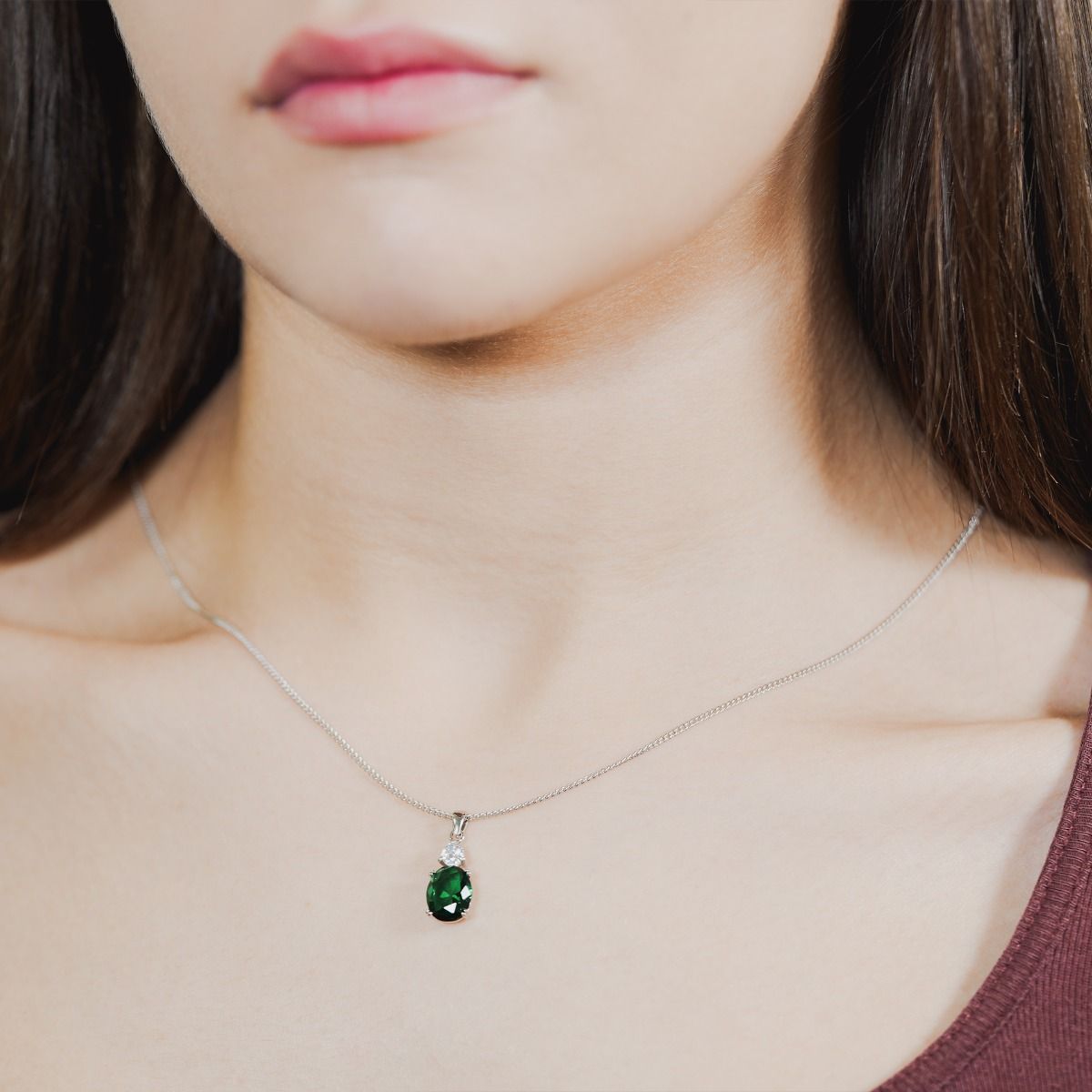 Unveil enchantment with our Emerald Round Double Drop Pendant. A stunning halo of flawlessly cut glass stones encircles an impressive cushion-cut centre stone, radiating a captivating allure. 