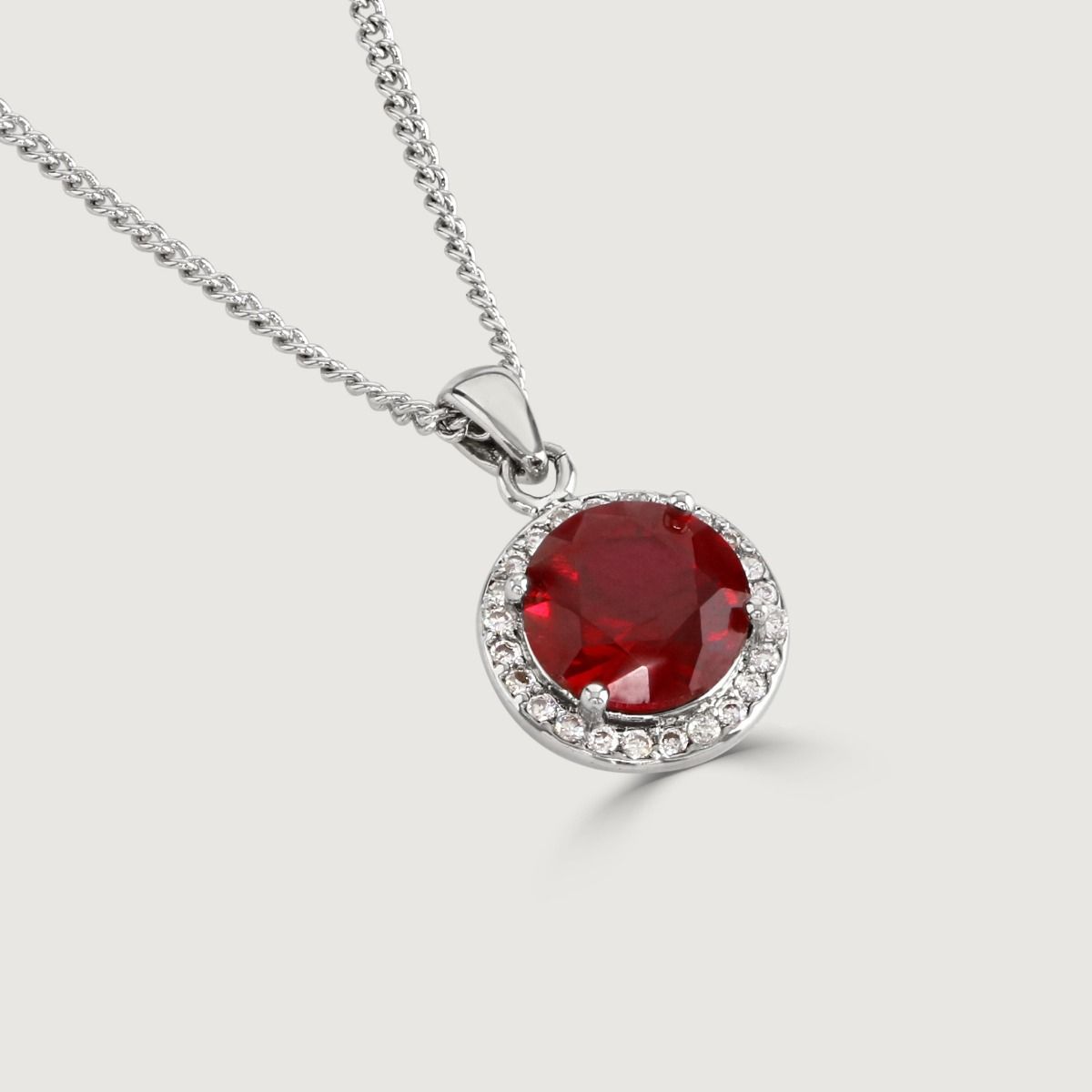 Experience enchantment through our Ruby Halo Pendant. The impressive round-cut centre stone emanates a captivating allure. Effortlessly elevate your style with this exquisite piece, infusing timeless glamour into any ensemble.