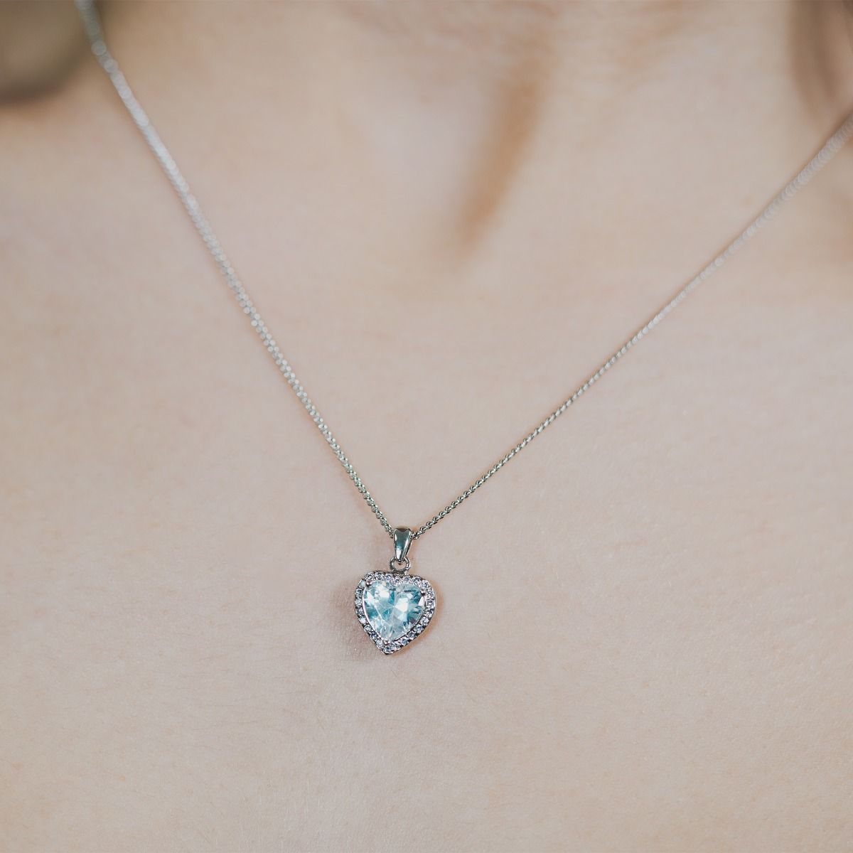 Embrace the allure of romance with our exquisite Clear Heart Pendant. A brilliant cubic zirconia takes centre stage, encircled by a mesmerising array of sparkling companions. 