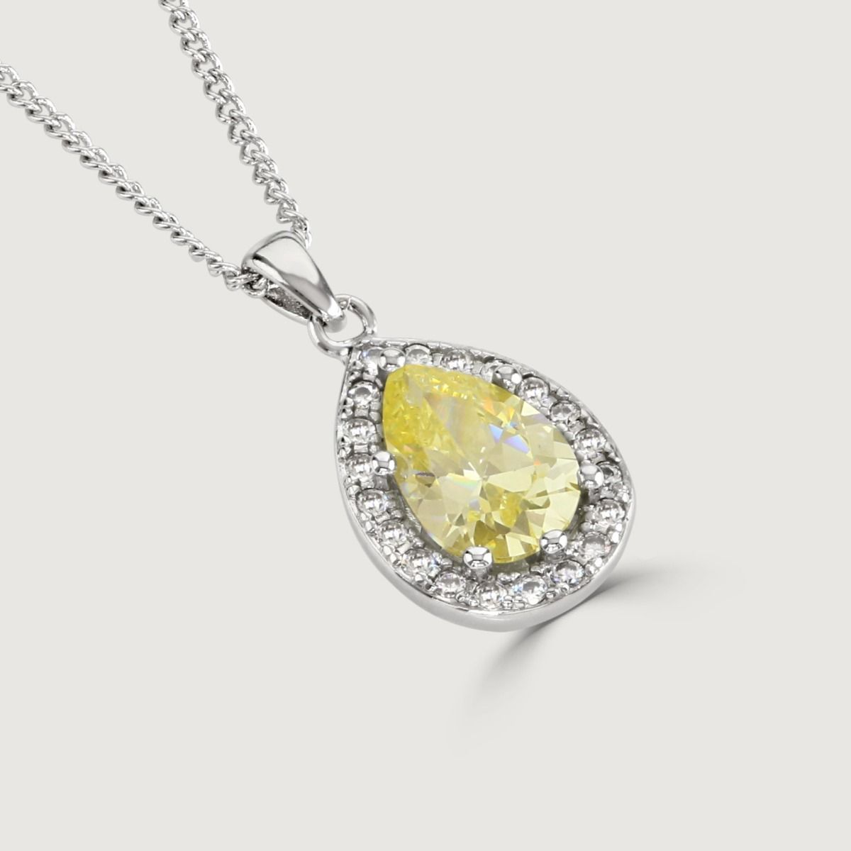 Elevate your elegance with our Canary Sparkle Pear Pendant. Meticulously crafted cubic zirconia stones frame a captivating canary pear cut centre, radiating sophistication. 