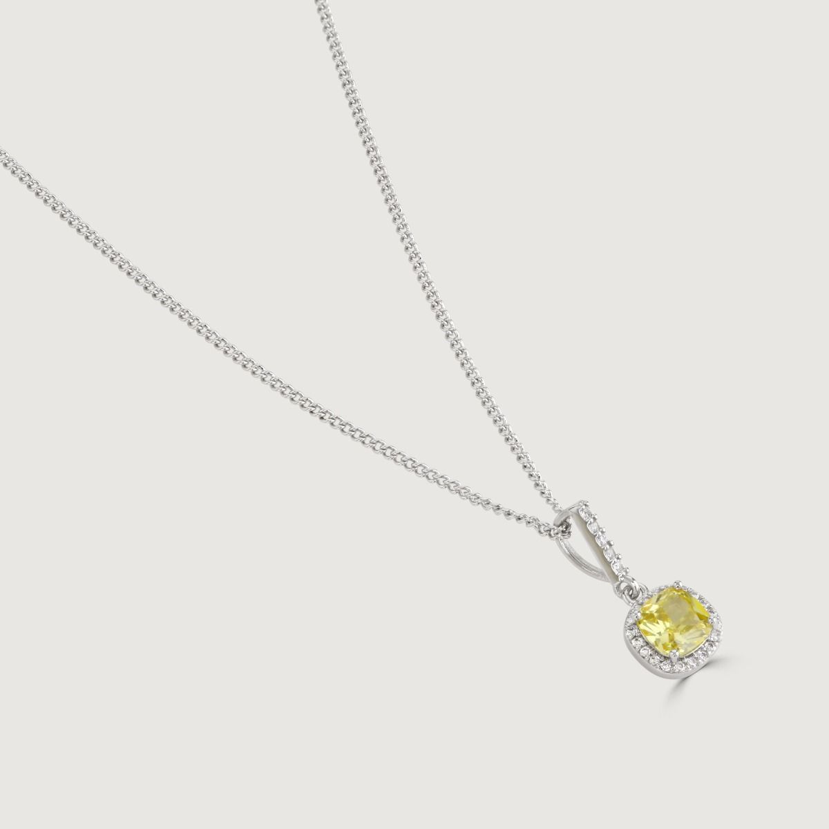 The Canary Cushion Drop Pendant is a enrapturing piece. Impeccably shaped cubic zirconia stones encircle a yellow diamond cushion cut centre, exuding a mesmerising allure.
