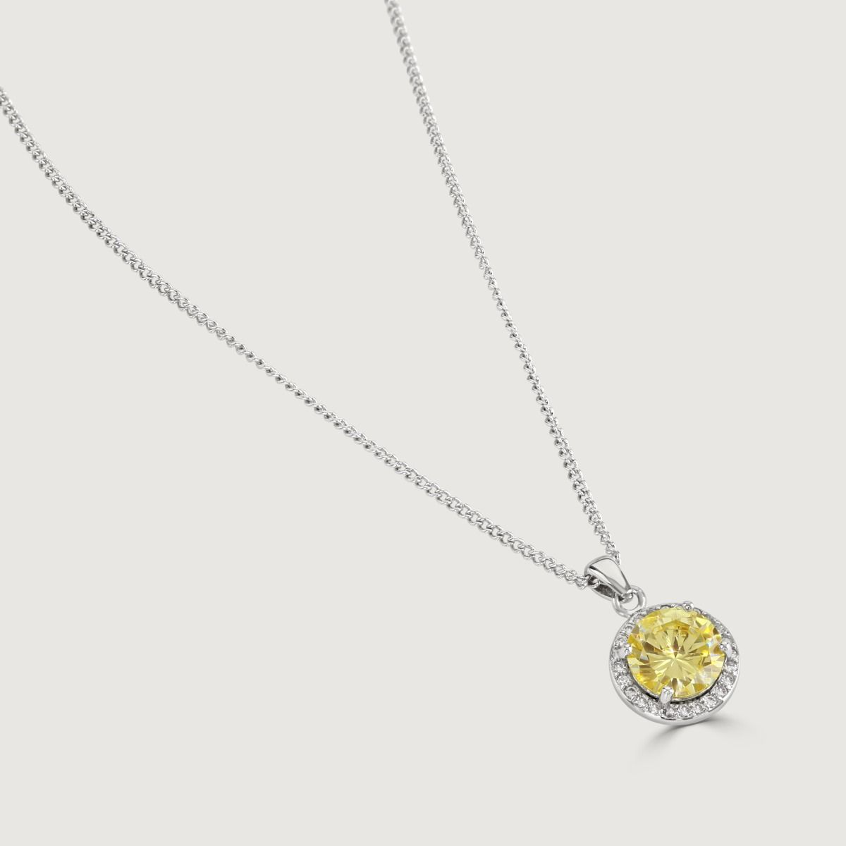Reveal the allure of our Canary Halo Solitare Pendant, adorned with meticulously crafted cubic zirconia stones encircling a radiant clear round-cut centre. Elevate your style effortlessly with this timeless piece.