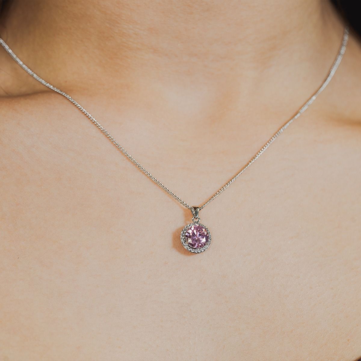 Experience enchantment through our Pink Halo Pendant. The impressive round-cut centre stone emanates a captivating allure. Effortlessly elevate your style with this exquisite piece, infusing timeless glamour into any ensemble.