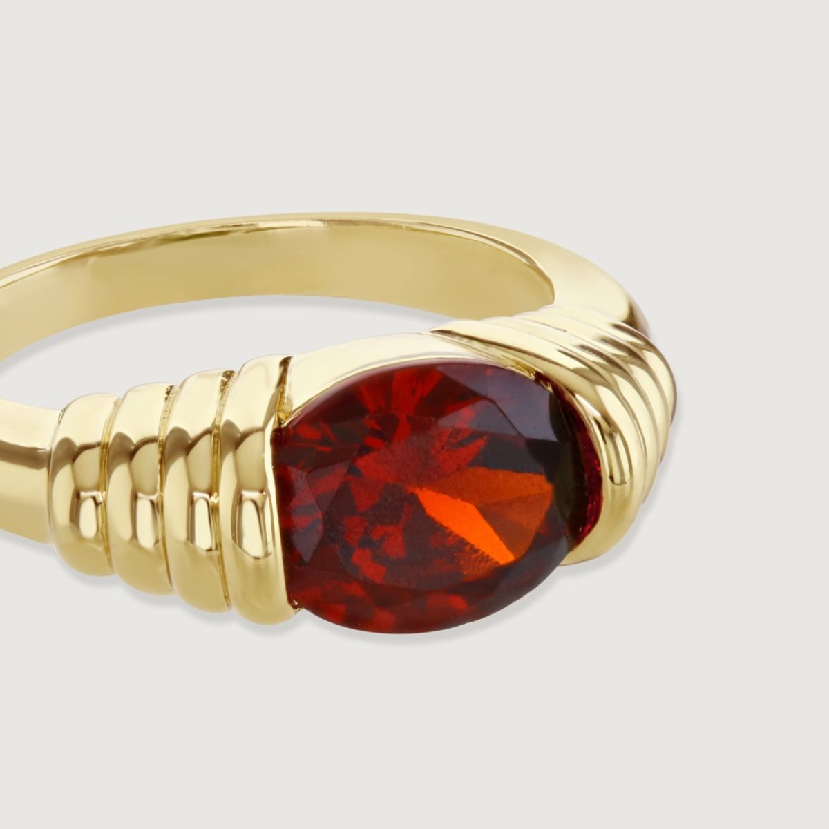 The Ancient Heirloom Ring, inspired by antiquity, features a bold cubic zirconia stone enveloped in gold bands, accentuating its prominence as a statement piece. With the stone as the captivating focal point, this ring becomes a cherished heirloom, symbol