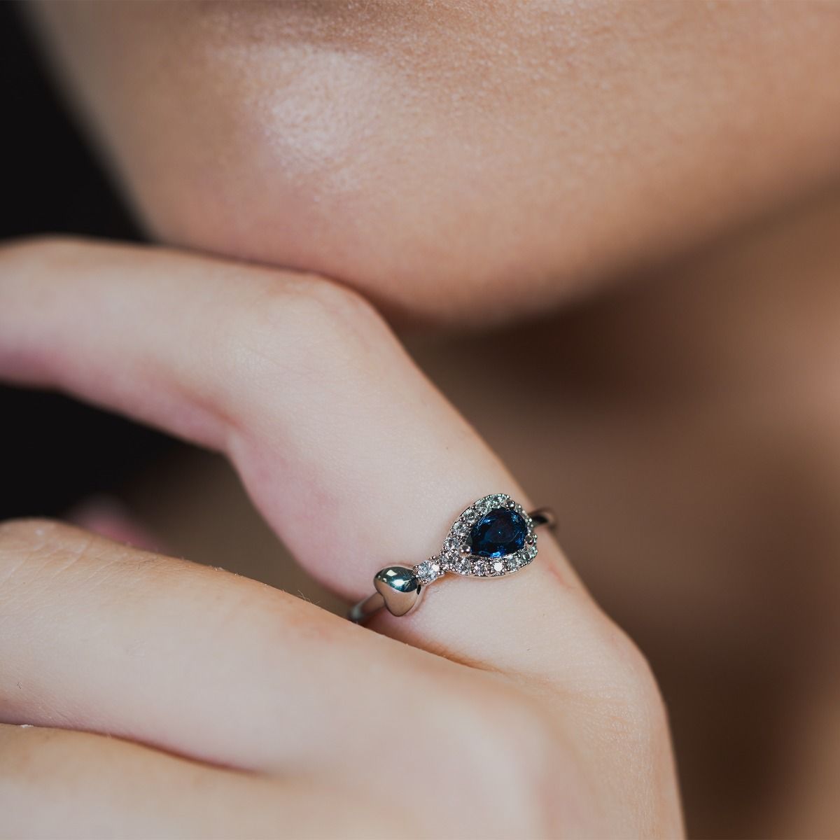 Discover elegance with our Sapphire Heart Pear-Drop Ring. Enhanced by cubic zirconia pear-drop band, it features a polished heart at the peak of the pear. The enchanting focal point is a captivating sapphire stone, which sits on a polished band.