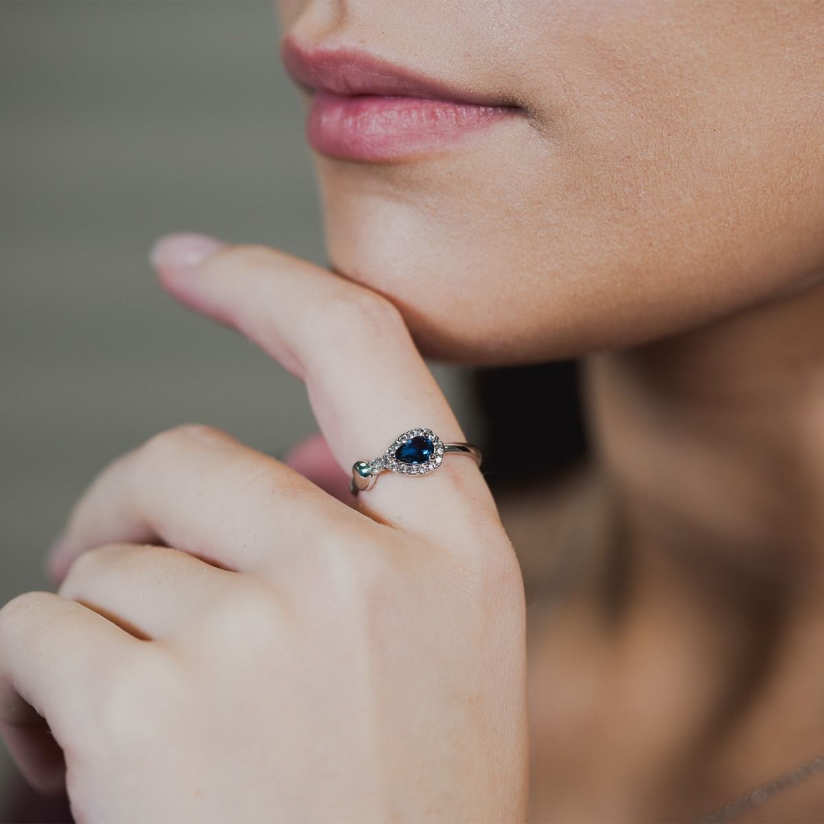 Discover elegance with our Sapphire Heart Pear-Drop Ring. Enhanced by cubic zirconia pear-drop band, it features a polished heart at the peak of the pear. The enchanting focal point is a captivating sapphire stone, which sits on a polished band.