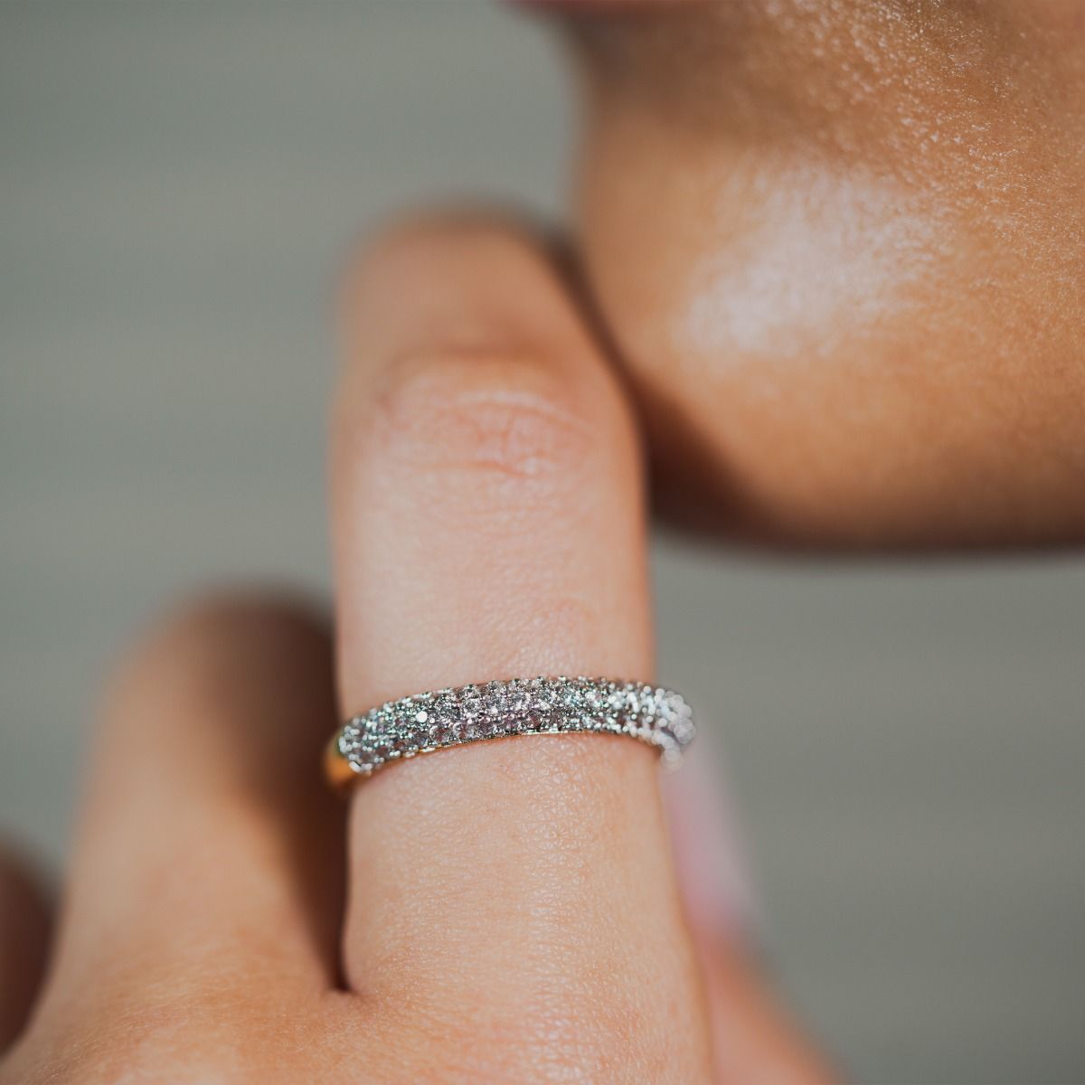Elegance shines with our Two-Tone Pave Cluster Ring. A gleaming gold-polished band adorned with an array of cubic zirconia stones, creating a stunning, sophisticated look that captures attention. This ring merges classic design with modern sparkle for a t