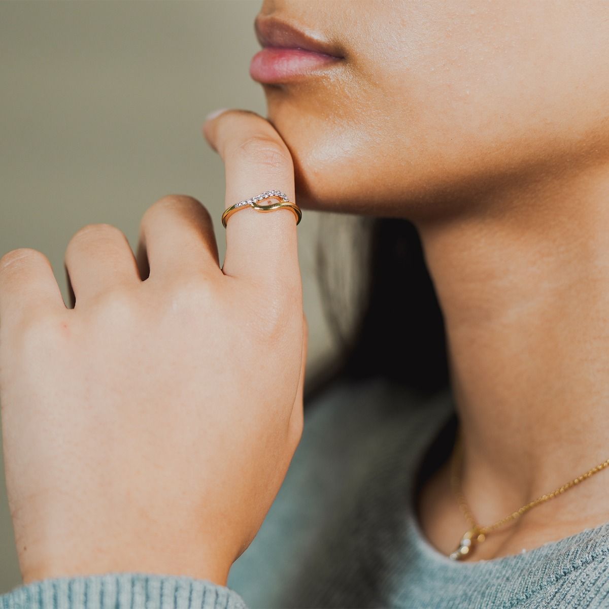 Elevate your style with the Two-Tone Pave and Polished Tide Ring. Crafted with precision, this necklace showcases intertwining gold-polished and cubic zirconia pave bands, creating a captivating organic design. 