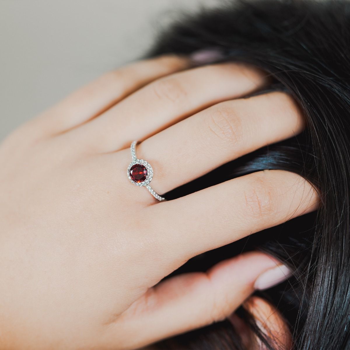 Make a statement with this stunning brilliant cut Ruby Halo Ring. Delicately surrounded with a halo of sparkling glass stones surrounding the centre stone and down the band, creating a dramatic, elegant look.