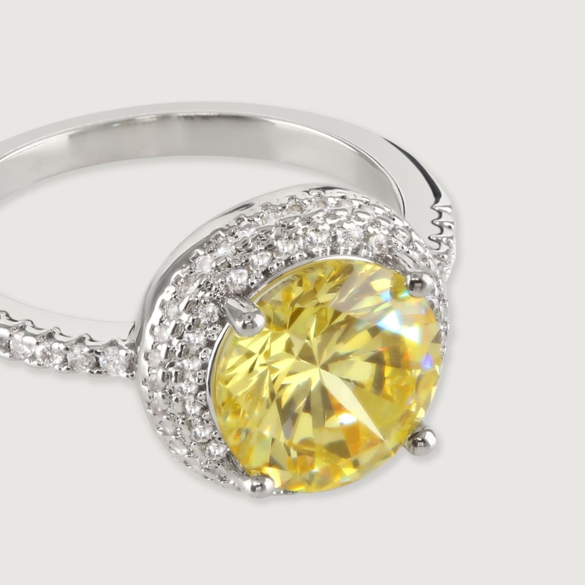Make a statement with this stunning brilliant cut canary ring. Delicately surrounded with a double halo of sparkling cubic zirconia stones surrounding the centre stone and down the band, creating a dramatic, elegant look.
