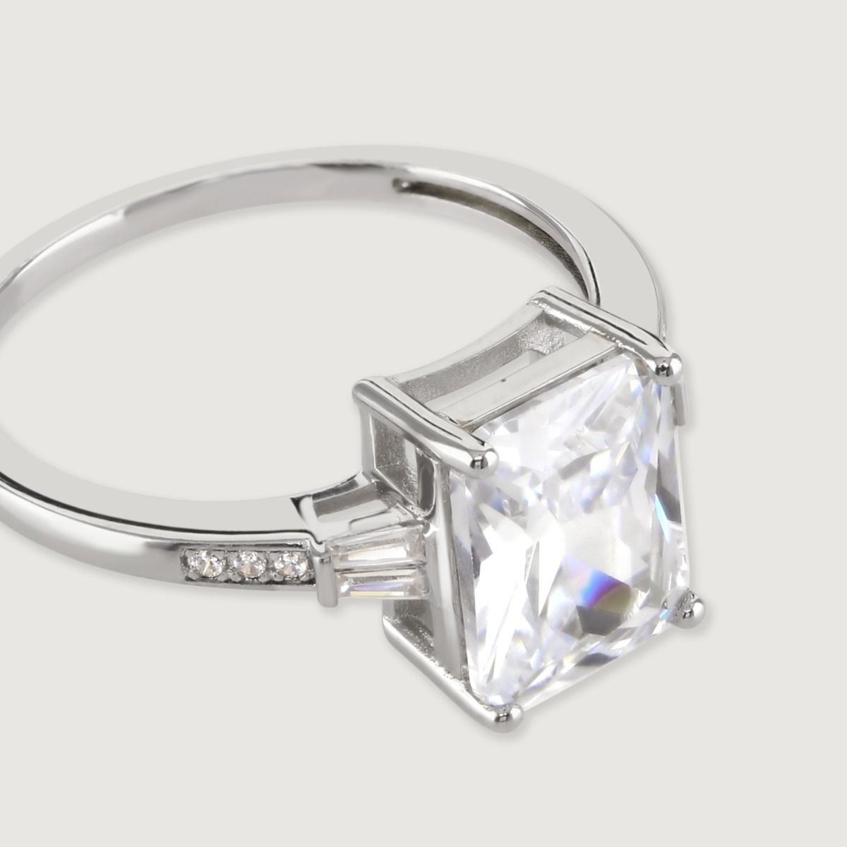 A stunning art deco inspired ring featuring an immaculate baguette cut central cubic zirconia stone, with tapered cubic zirconia baguette sides flawlessly faceted for maximum sparkle.