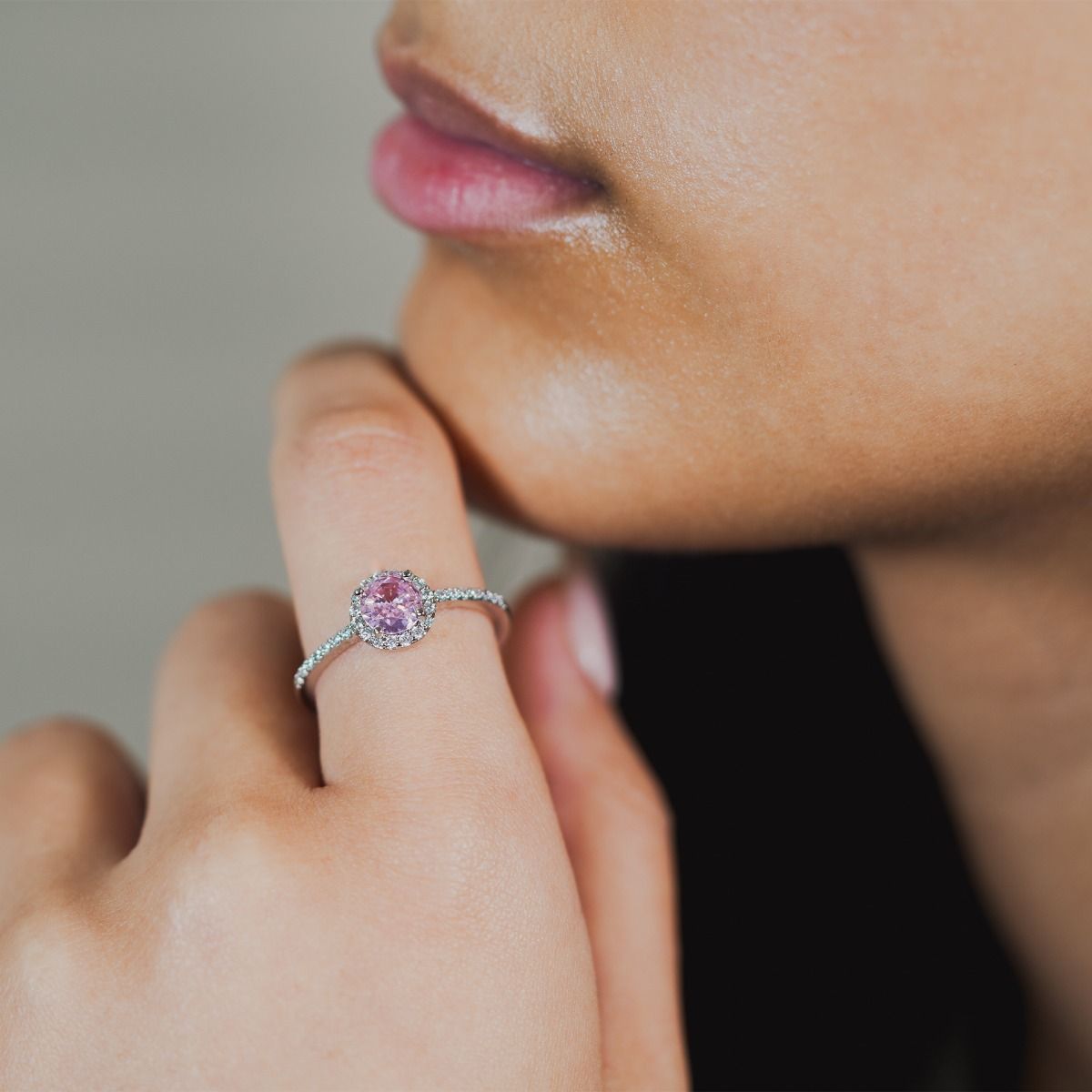 Make a statement with this stunning brilliant cut dazzling pink ring. Delicately surrounded with a halo of sparkling cubic zirconia stones surrounding the centre stone and down the band, creating a dramatic, elegant look.