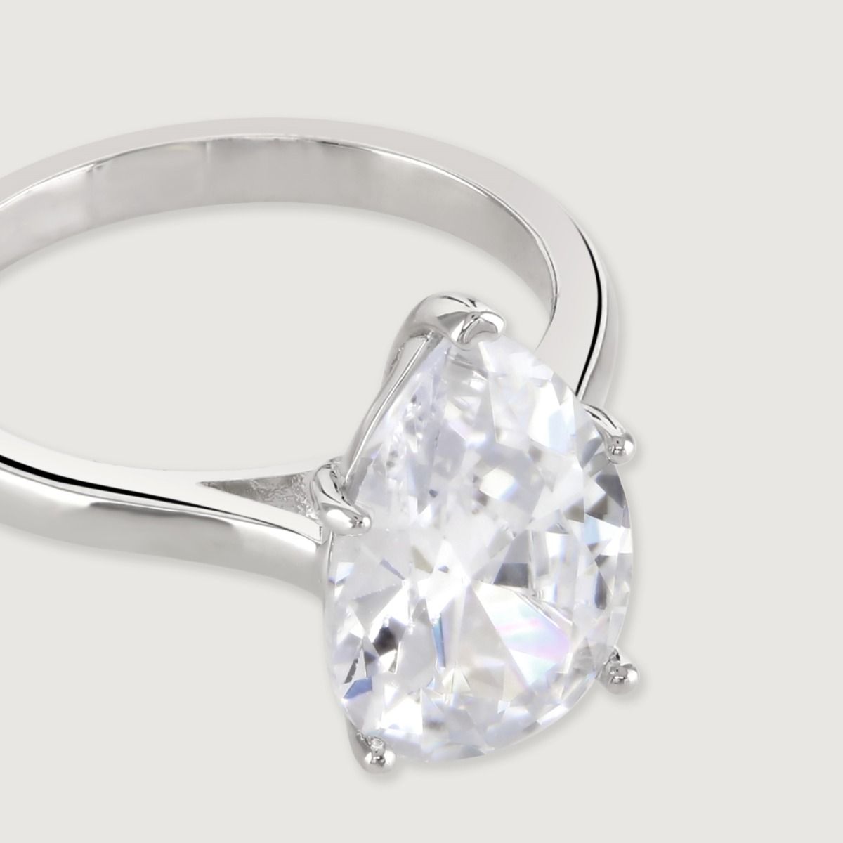 Timeless and elegant, this simply stunning solitaire ring features a pear cut cubic zirconia at it’s centre on a band of cool, polished rhodium plating. An ultimate classic, perfect for any occasion.