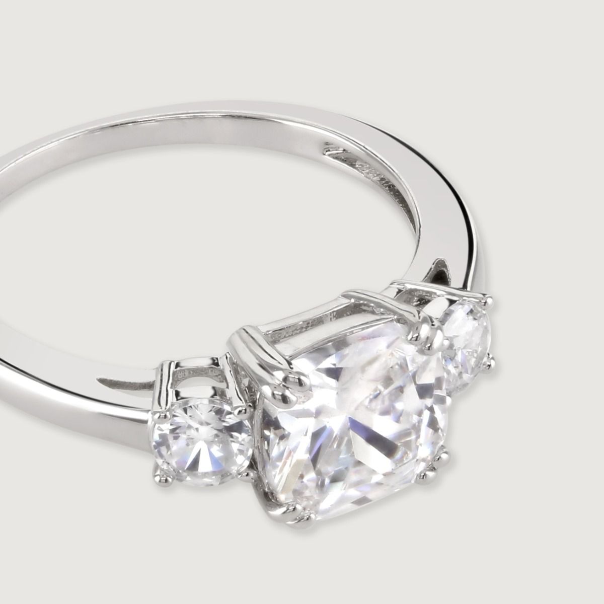 A truly dazzling design, this stunning ring features an emerald cut cubic zirconia centre stone between two smaller  brilliant cut clear cubic zirconia stones. 