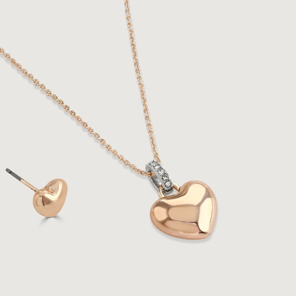 This sweet pendant and earrings set makes the perfect gift for someone special. The pendant features slender rose gold tone chain, decorated with a trio of beautiful heart charms in polished rose gold tone, silver tone with clear crystals, and gold tone w