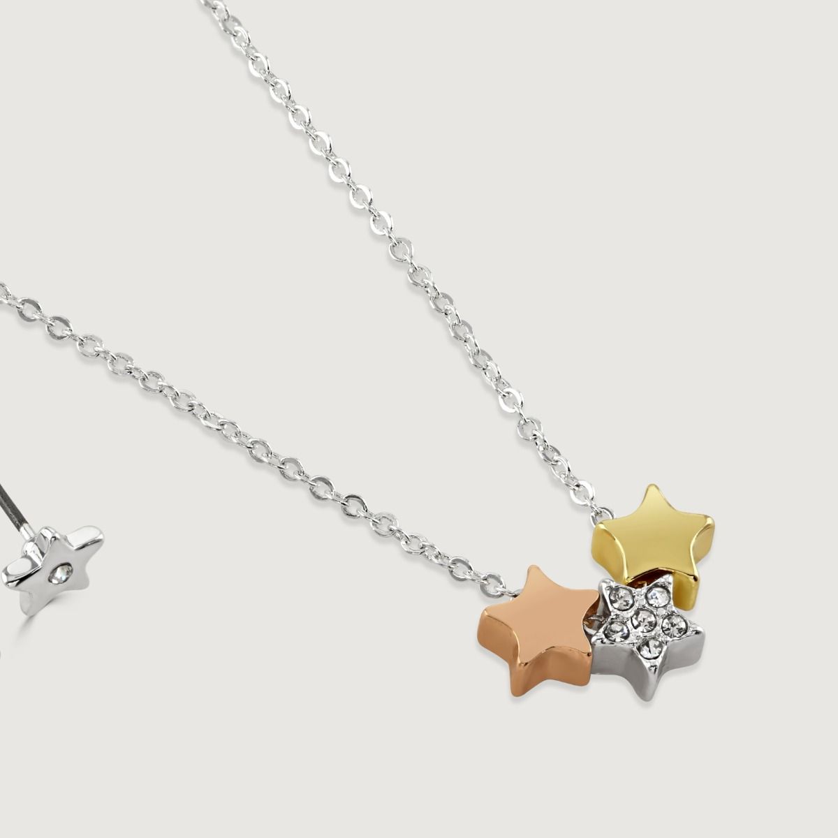 The Starburst pendant and earring set features delicate stars in silver plate, rose gold and gold tones with exquisite crystal detailing. Three stars are suspended from a silver-plated chain and paired with silver plated stud earrings, making this the per