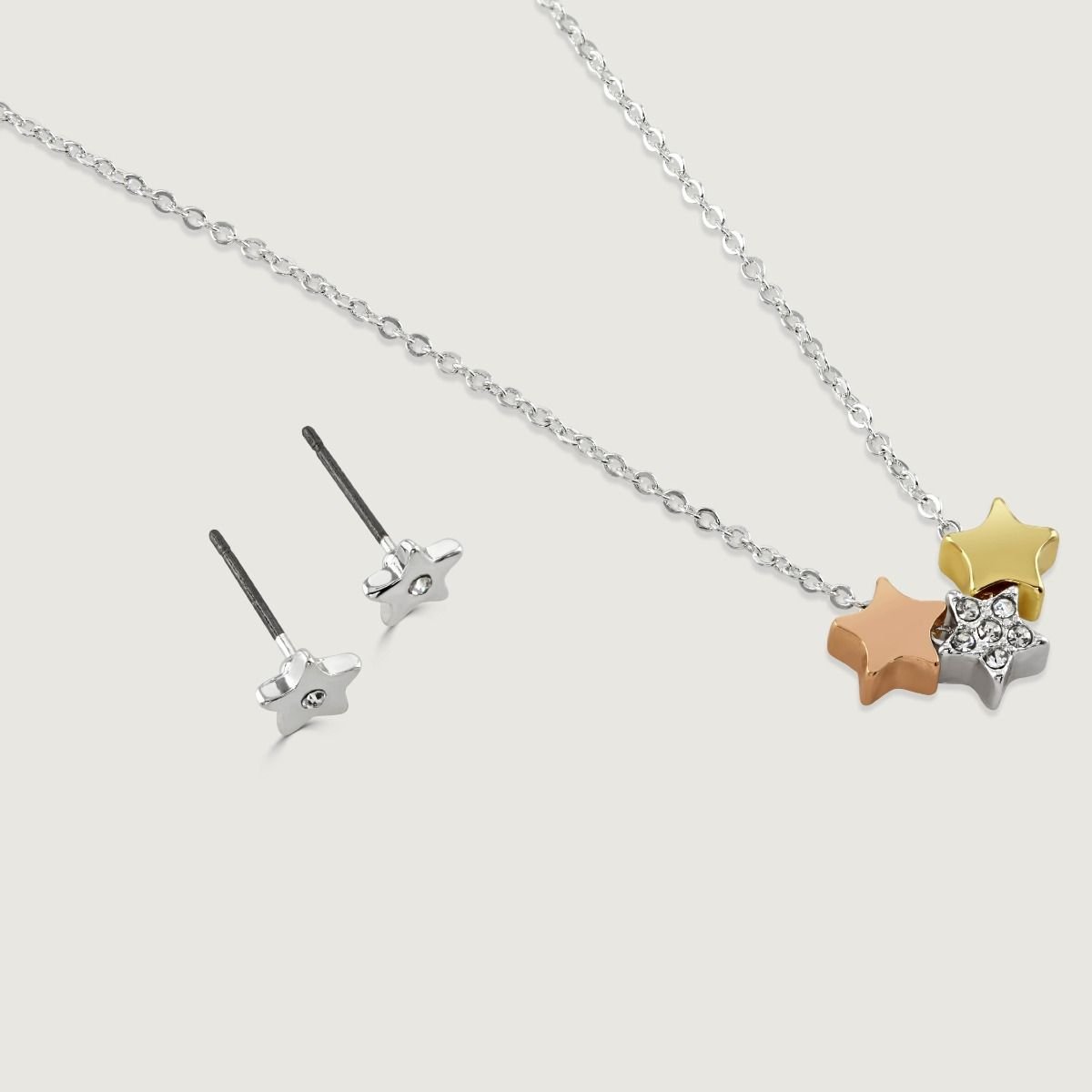 The Starburst pendant and earring set features delicate stars in silver plate, rose gold and gold tones with exquisite crystal detailing. Three stars are suspended from a silver-plated chain and paired with silver plated stud earrings, making this the per