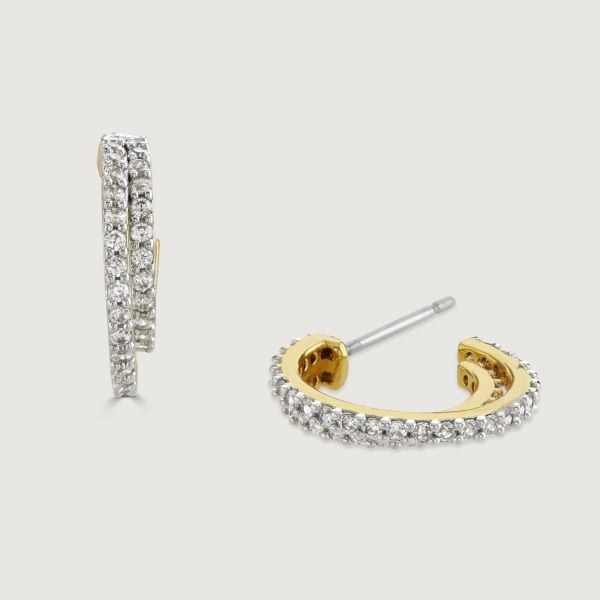 Elevate your style with our Two-Tone Pave Double Hoop Earrings. The small hoop elegantly embraces a larger hoop, adorned with sparkling cubic zirconia stones. This is a timeless design that adds sophistication to any look. 